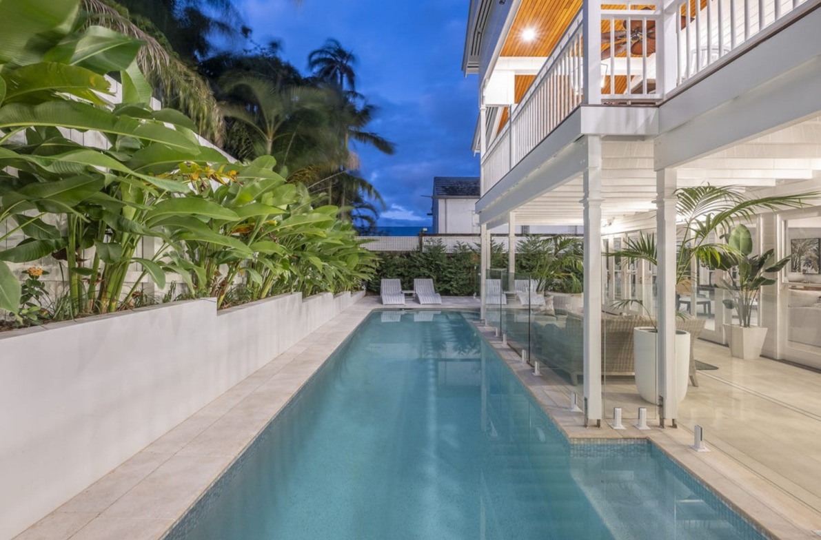 Lap pool alongside Hamptons-style verandah at dusk