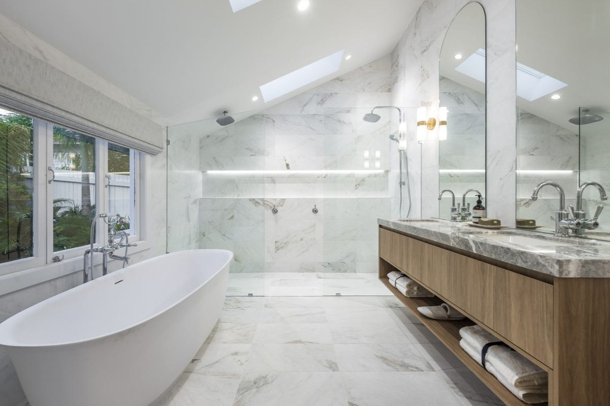 Marble ensuite with freestanding bath and skylights