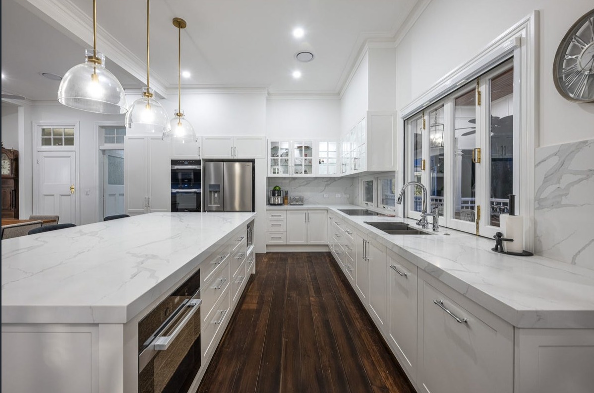 Classic white kitchen with marble benchtops and timber floors