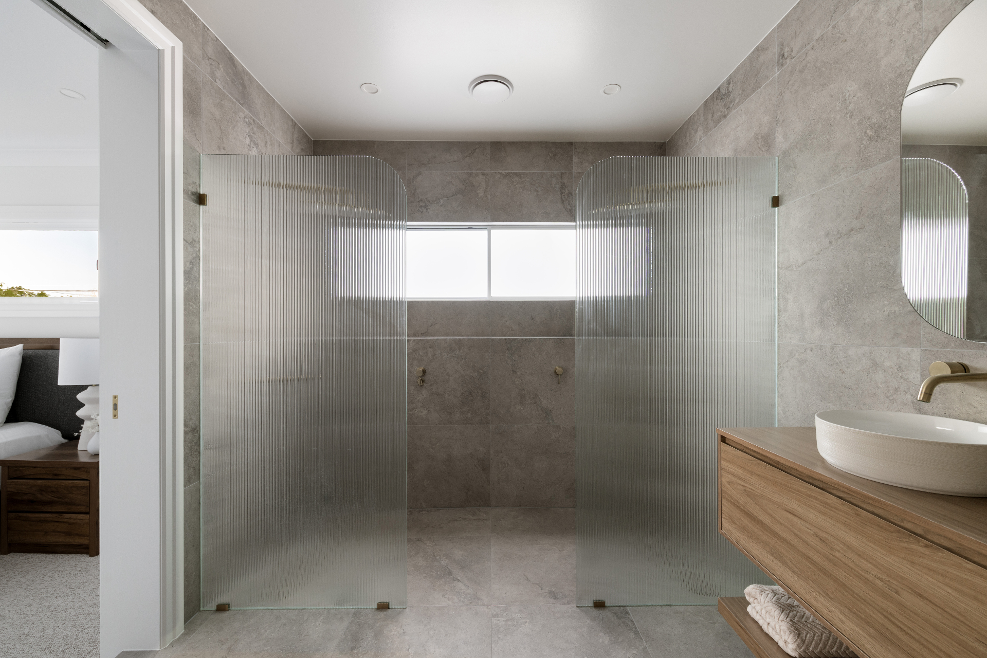 Ensuite with fluted glass shower screens and timber vanity, Geebung